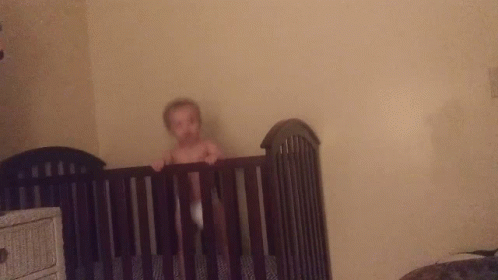 Baby Without Shirt In Black Crib GIF