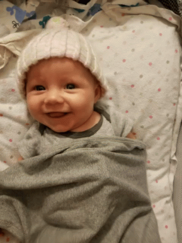 Baby Wrapped in Blanket Wearing Hat