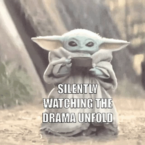 Baby Yoda Holding Cell Phone Silently Watching Drama Unfold