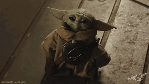 Baby Yoda Holding Helmet
