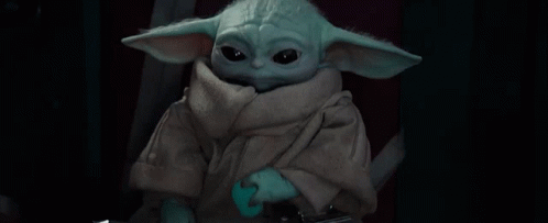 Baby Yoda Holding Sword Looking at Camera
