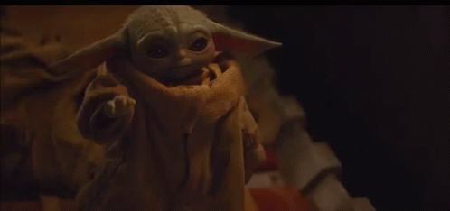 Baby Yoda Looking at Camera on Bed