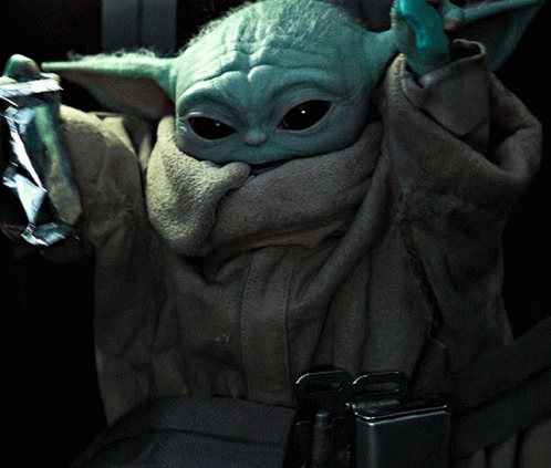 Baby Yoda Sitting in Car Seat Holding Foil