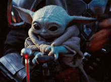 Baby Yoda Sitting on Lap with Cane