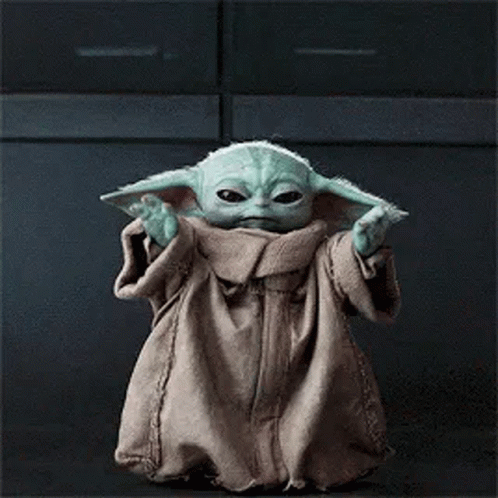 Baby Yoda Standing in Front of Dark Background