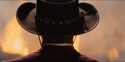 Back of Man in Cowboy Hat Watching Fire