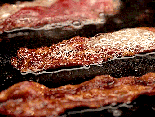 Bacon Is Being Cooked In A Frying Pan GIF