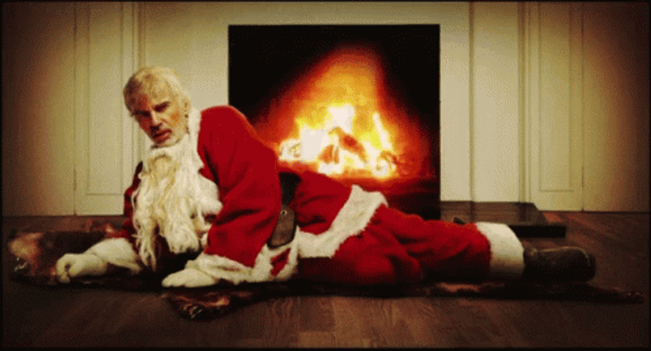 Bad Santa On The Fireplace GIF
