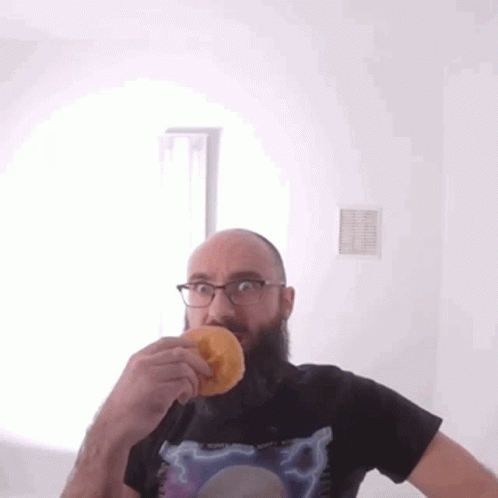 Bald Bearded Man Eating Donut