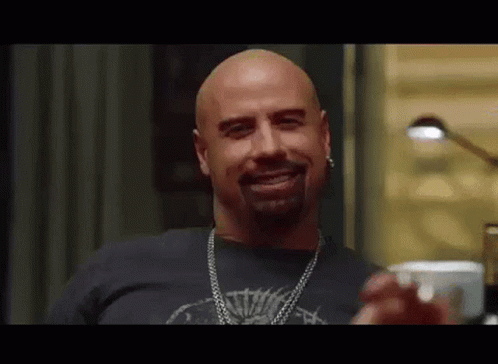 Bald Bearded Man in Black Shirt and Chain