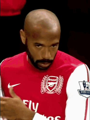 Bald Bearded Man in Red Fly Emirates Shirt