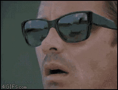 Bald Bearded Man Wearing Sunglasses and Earbuds