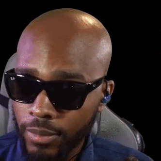 Bald Bearded Man Wearing Sunglasses and Earbuds