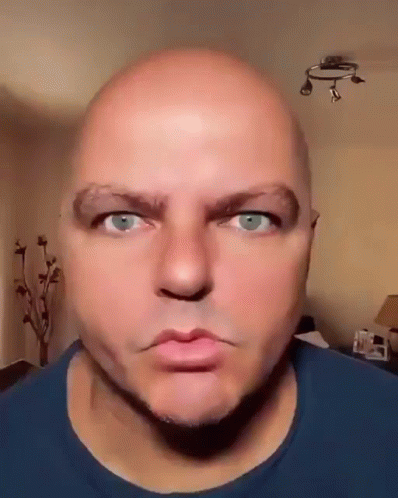 Bald Blue-Eyed Bearded Man in Blue Shirt Funny Face