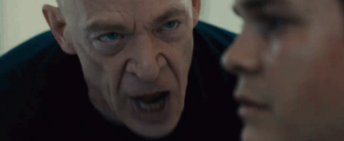 Bald Blue-Eyed Man Looking at Another Man