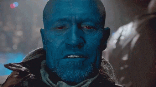 Bald Blue-Faced Man with Beard Looking at Camera