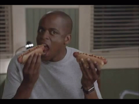 Bald Guy Eating Two Glizzy GIF