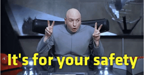 Bald Man at Desk Saying It's for Your Safety
