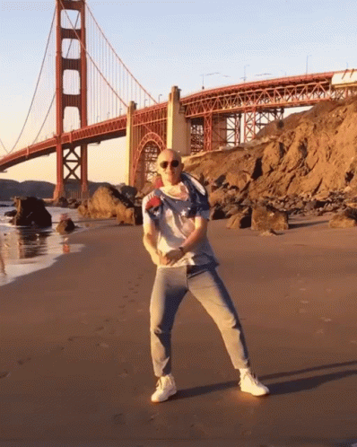 Bald Man Dancing On Beach GIF