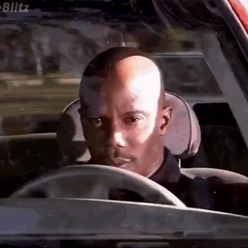 Bald Man Driving Car