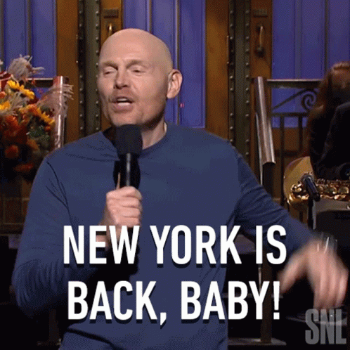 Bald Man Holding Microphone Says New York Is Back
