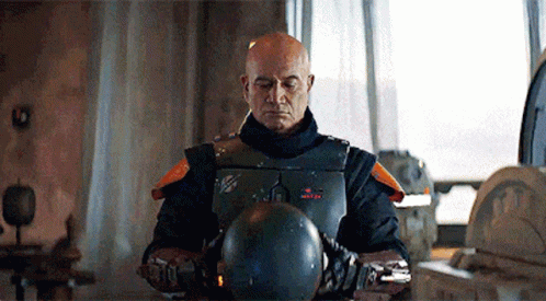 Bald Man in Armor Holding Helmet