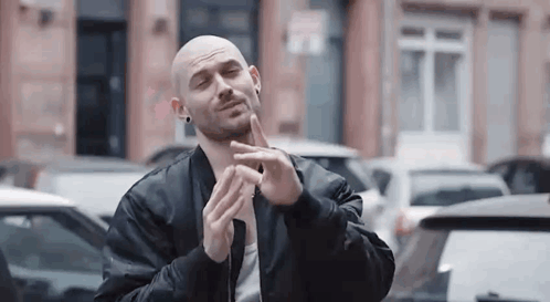 Bald Man in Black Jacket Making Funny Face in Parking Lot