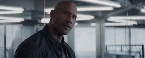 Bald Man in Black Jacket Standing Serious