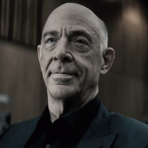 Bald Man in Black Shirt and Suit Smiling