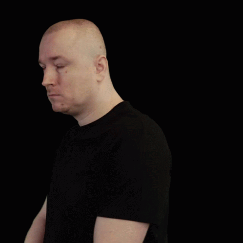 Bald Man in Black Shirt Crosses Arms