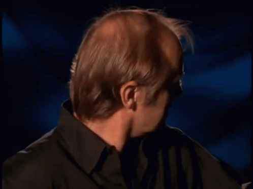 Bald Man in Black Shirt Making Funny Face