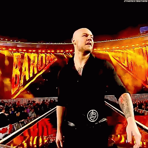 Bald Man In Black Shirt With Crowd And Baron Sign GIF