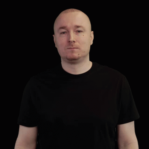 Bald Man in Black T-Shirt Looking Sideways
