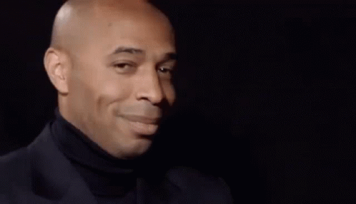 Bald Man in Black Turtleneck and Suit Looking to the Side