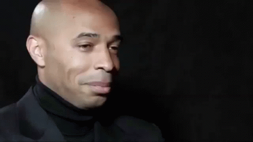 Bald Man In Black Turtleneck And Suit Smiling GIF