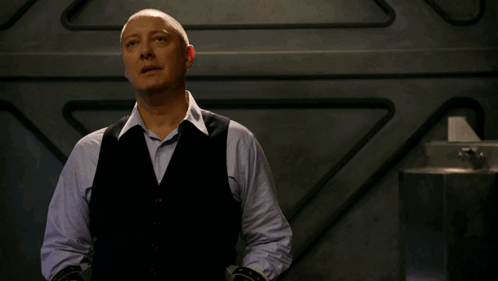 Bald Man in Black Vest and Blue Shirt