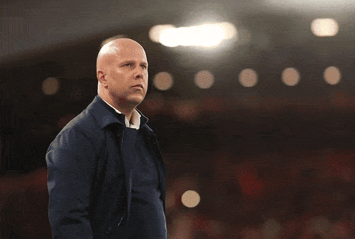 Bald Man in Blue Jacket in Front of Sa Mu Sign