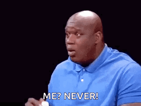 Bald Man in Blue Shirt Holding White Ball