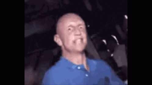 Bald Man in Blue Shirt Making Funny Face