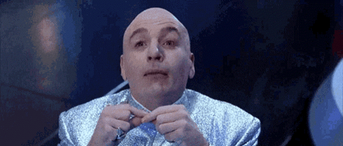 Bald Man in Blue Suit Holding Pen