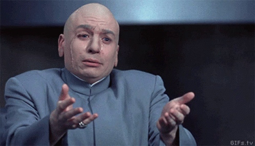 Bald Man in Blue Suit Pointing With Ring