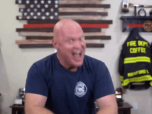 Bald Man In Fire Department Shirt Making Funny Face GIF