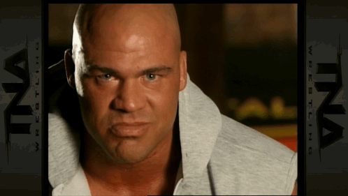 Bald Man In Front Of Ina Wrestling Ad GIF