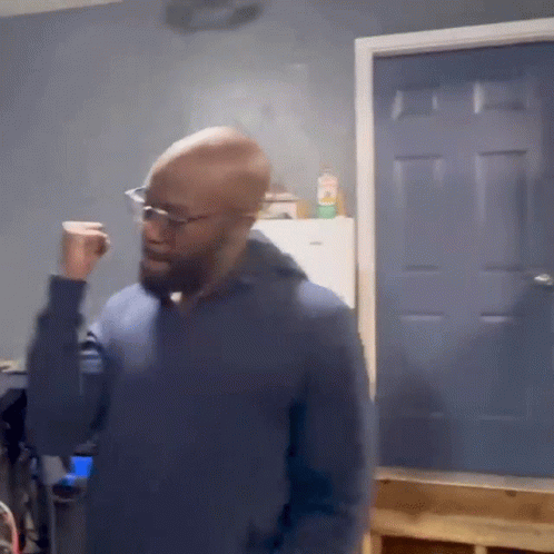 Bald Man in Glasses and Blue Sweater at Blue Door