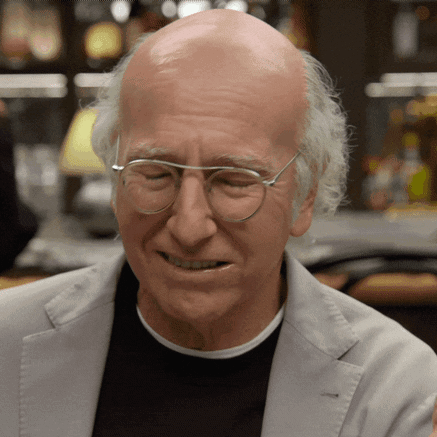Bald Man in Glasses and Grey Jacket Smiling