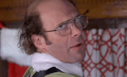 Bald Man In Glasses And Santa Hat By Christmas Tree GIF