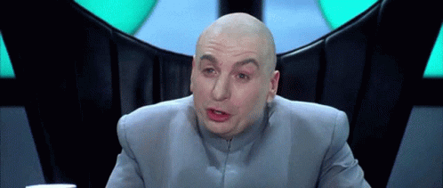Bald Man in Gray Suit Making Funny Face
