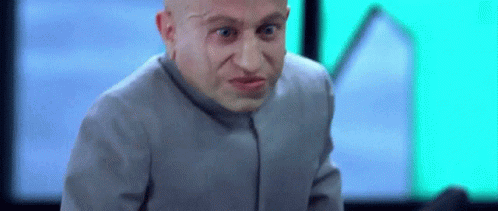 Bald Man in Gray Suit Making Funny Face Looking at Camera