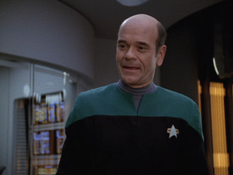 Bald Man in Green and Black Uniform with Star
