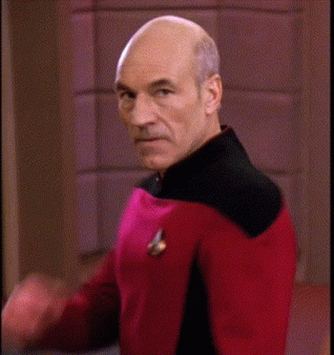 Bald Man In Red And Black Uniform Making Funny Face GIF